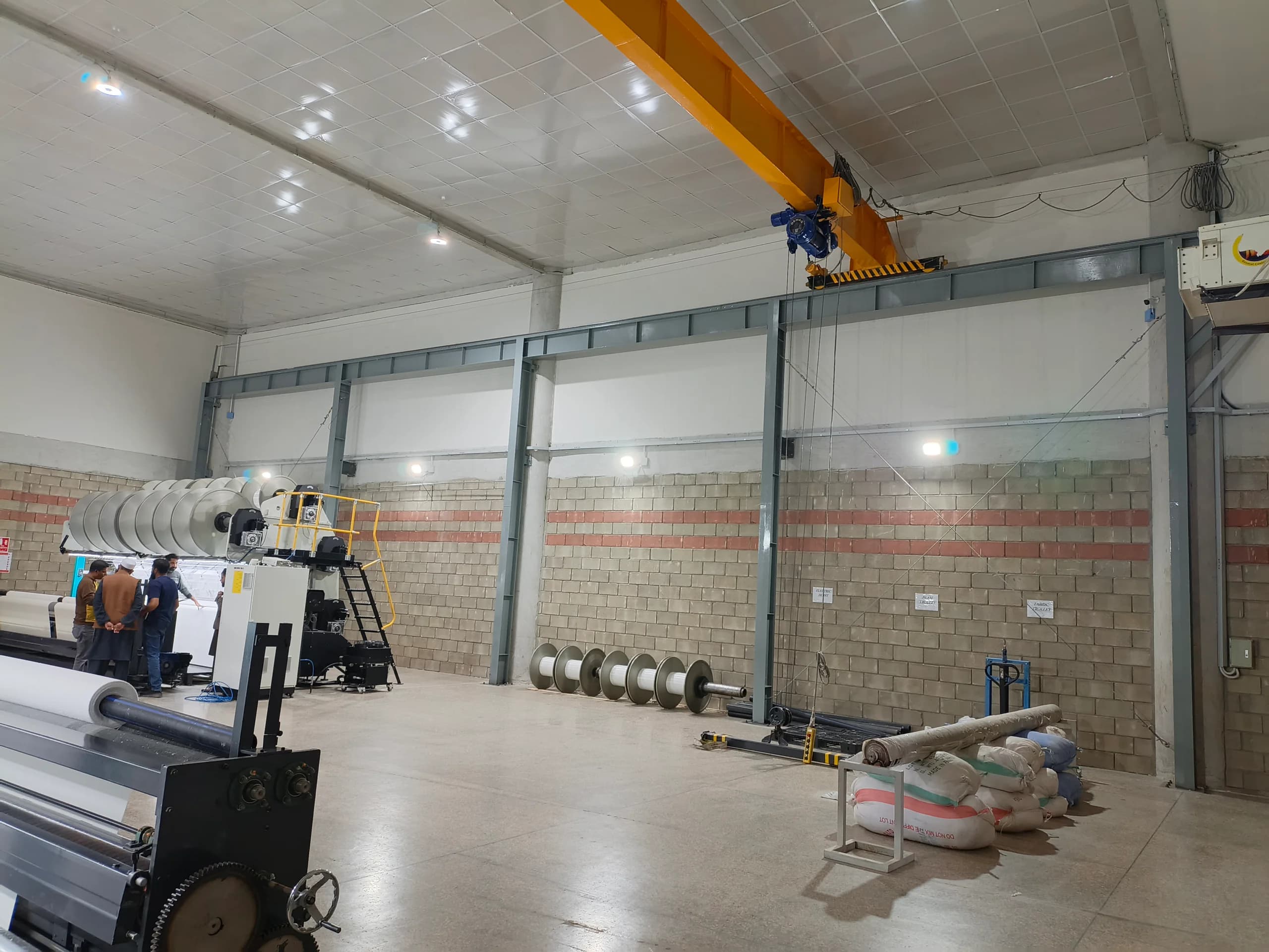 Overhead crane operating inside an industrial facility